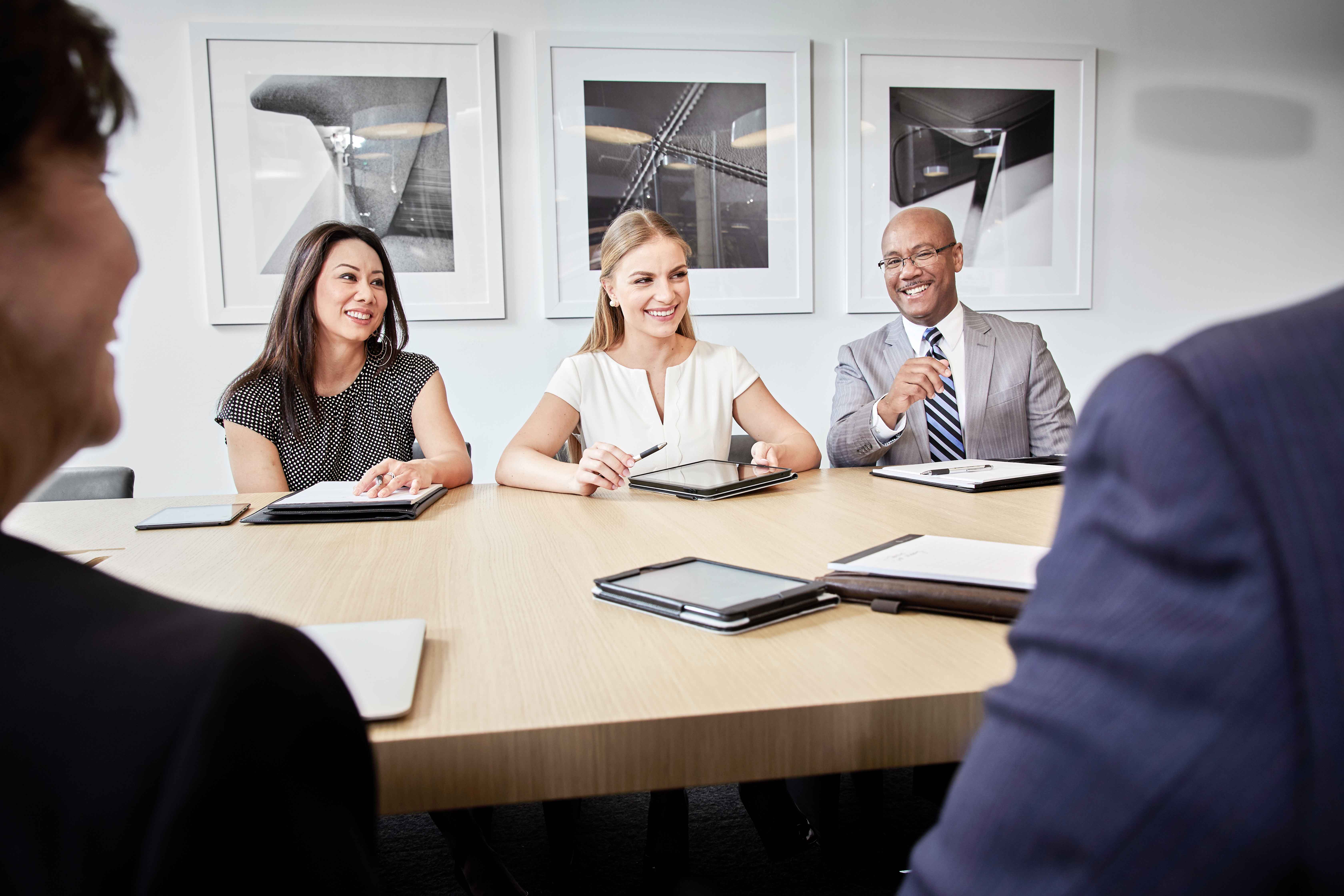 Group of people in business meeting smiling